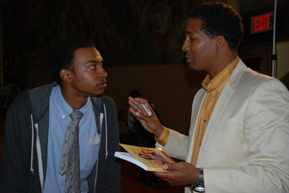 Alwyn Smith, left, a junior at the Eagle Academy for Young Men in the Bronx, speaks with Mark Johnson, an author, at the end of Eagle Week.